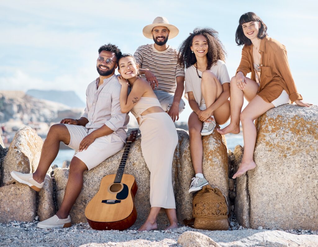 Shot of a group of friends enjoying their time together at the beach