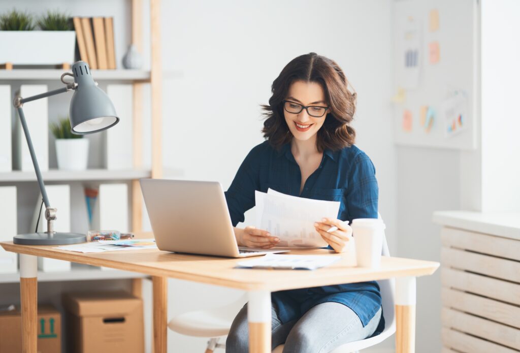 Woman working in Cyprus on her desk with a laptop, focusing on her tasks.