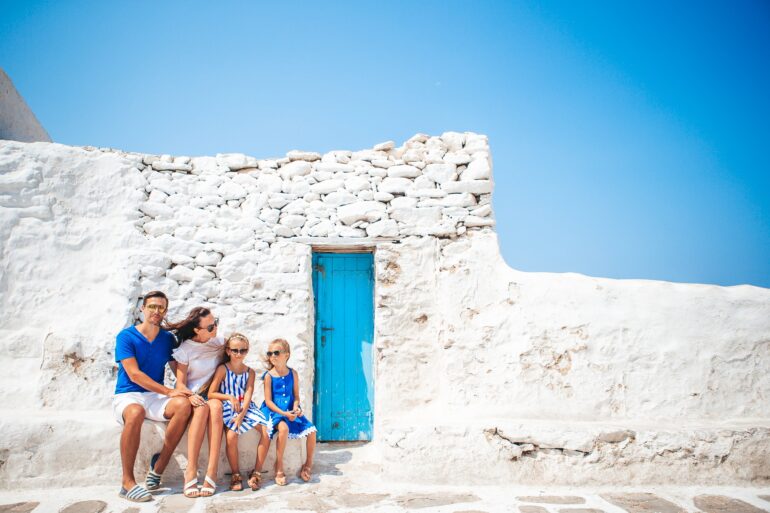 Family at street of typical greek traditional village.